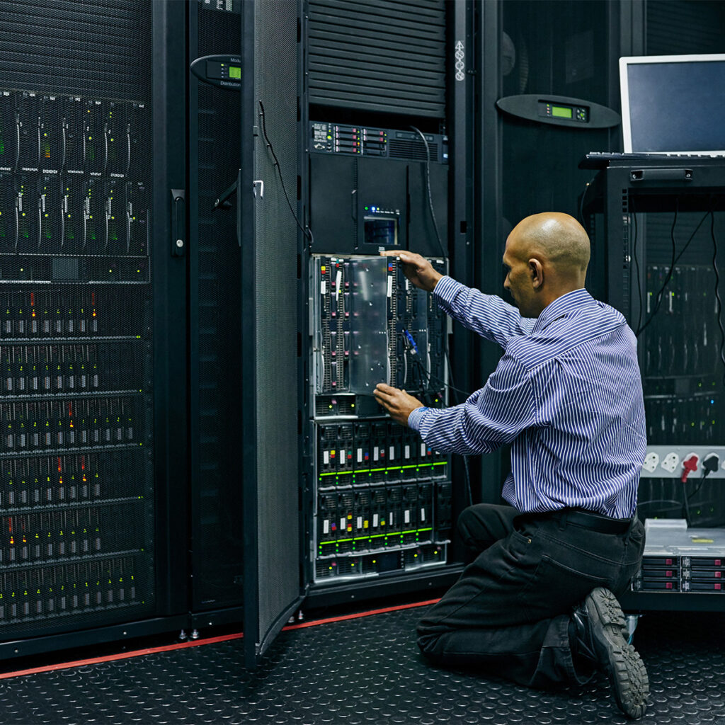it technician working on a server rack